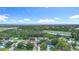Expansive aerial view of a residential neighborhood with lush greenery and distant highway and waterway views at 6511 3Rd Ne Ave, Bradenton, FL 34208