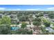 An aerial view showing the property and surrounding neighborhood with mature trees and blue skies at 6511 3Rd Ne Ave, Bradenton, FL 34208