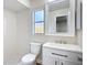 Bright bathroom featuring a white vanity with modern fixtures and a shower with decorative pebble flooring at 6511 3Rd Ne Ave, Bradenton, FL 34208