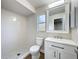 Bathroom with shower, toilet, vanity with sink, and a small frosted window at 6511 3Rd Ne Ave, Bradenton, FL 34208