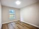 This bedroom is bright, has wood-look flooring and a window with a yard view at 6511 3Rd Ne Ave, Bradenton, FL 34208