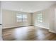 Spacious bedroom with new vinyl plank flooring, fresh paint, and two windows offering ample natural light at 6511 3Rd Ne Ave, Bradenton, FL 34208