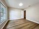 Bedroom with wood-look flooring, a window view, and light-colored paint at 6511 3Rd Ne Ave, Bradenton, FL 34208