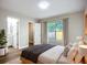 A bedroom with bathroom access, nice flooring, a window, and curtains at 6511 3Rd Ne Ave, Bradenton, FL 34208