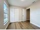 Bedroom featuring wood-look floors, closet, and a window offering natural light at 6511 3Rd Ne Ave, Bradenton, FL 34208