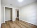 Bright bedroom with neutral paint, wood-look flooring, closet, and a view to another room at 6511 3Rd Ne Ave, Bradenton, FL 34208