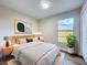 This staged bedroom features warm lighting, stylish decor, and a view of the backyard at 6511 3Rd Ne Ave, Bradenton, FL 34208
