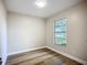 A small bedroom has nice flooring, a window with a pleasant view, and neutral paint at 6511 3Rd Ne Ave, Bradenton, FL 34208