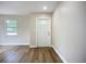 Bright entryway featuring new vinyl plank flooring, fresh paint, and a welcoming front door at 6511 3Rd Ne Ave, Bradenton, FL 34208