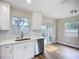 Bright kitchen featuring stainless steel appliances, white marble backsplash, and hardwood floors at 6511 3Rd Ne Ave, Bradenton, FL 34208