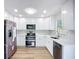 Modern kitchen featuring white cabinets, stainless steel appliances, and marble backsplash at 6511 3Rd Ne Ave, Bradenton, FL 34208