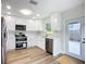 Bright kitchen featuring stainless steel appliances, marble backsplash and a door to the backyard at 6511 3Rd Ne Ave, Bradenton, FL 34208