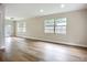 Bright living room with hardwood floors, two large windows, and neutral paint at 6511 3Rd Ne Ave, Bradenton, FL 34208