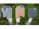 Aerial view of the back of three houses with well-manicured lawns, one of which has a screened-in pool at 8731 Tantallon Cir, Tampa, FL 33647