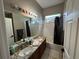 This bathroom boasts a double vanity, granite counters, and a shower-tub combo at 8731 Tantallon Cir, Tampa, FL 33647