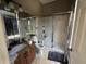 Bathroom with granite vanity, shower, and tile floors at 8731 Tantallon Cir, Tampa, FL 33647