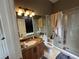Bathroom with granite vanity, shower, and lighting at 8731 Tantallon Cir, Tampa, FL 33647