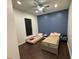 This bedroom offers sleek wood floors, a dark accent wall, and lots of natural light at 8731 Tantallon Cir, Tampa, FL 33647