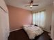 This bedroom features wood floors, a ceiling fan, and a large window for natural light at 8731 Tantallon Cir, Tampa, FL 33647