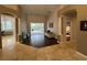 A gorgeous entryway with tile and hardwood floors, columns, high ceilings, and easy access to the patio and bedroom at 8731 Tantallon Cir, Tampa, FL 33647
