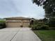 Charming one-story home with a three-car garage, well-manicured lawn, and mature landscaping at 8731 Tantallon Cir, Tampa, FL 33647