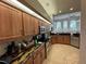 This kitchen features wood cabinets, granite counters and stainless steel appliances at 8731 Tantallon Cir, Tampa, FL 33647