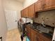 Convenient laundry room with granite counters, plenty of cabinet space and a utility sink at 8731 Tantallon Cir, Tampa, FL 33647
