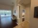 Inviting living area with wood floors, view to pool and access to bedroom at 8731 Tantallon Cir, Tampa, FL 33647