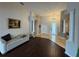 Elegant foyer with hardwood floors, chandelier, and decorative columns for architectural flair at 8731 Tantallon Cir, Tampa, FL 33647