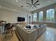 Inviting living room with lots of natural light, a ceiling fan, and neutral decor at 8731 Tantallon Cir, Tampa, FL 33647