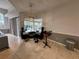 Bright living room with travertine floors, view of pool, and light fixture at 8731 Tantallon Cir, Tampa, FL 33647