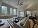 Spacious living room with large windows, travertine floors, and stylish decor at 8731 Tantallon Cir, Tampa, FL 33647