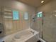 Bright main bathroom with a garden tub, separate shower, and plantation shutters at 8731 Tantallon Cir, Tampa, FL 33647