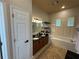 Bright main bathroom featuring double sinks, soaking tub, and plantation shutters at 8731 Tantallon Cir, Tampa, FL 33647