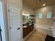 Bright main bathroom featuring double sinks, soaking tub, and plantation shutters at 8731 Tantallon Cir, Tampa, FL 33647