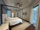 Spacious main bedroom boasts a four-post bed, ceiling fan and private outdoor access at 8731 Tantallon Cir, Tampa, FL 33647