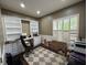 A cozy office featuring custom built-in bookshelves and drawers, plantation shutters, and a modern, neutral color palette at 8731 Tantallon Cir, Tampa, FL 33647