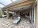 A comfortable patio with various seating options and ceiling fans for relaxation and enjoyment of outdoor space at 8731 Tantallon Cir, Tampa, FL 33647