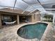 Screened-in lanai with pool, brick pavers, a hammock and outdoor seating in a private backyard at 8731 Tantallon Cir, Tampa, FL 33647