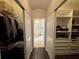 Large walk-in closet with custom shelving and convenient access to the main bath at 8731 Tantallon Cir, Tampa, FL 33647