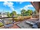 Inviting deck with lounge chairs, decorative rug, and stylish railing, perfect for relaxing and taking in the surrounding scenery at 101 Carlyle Dr, Palm Harbor, FL 34683