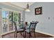 Cozy dining area featuring a glass table, decorative chairs, and access to the outdoor deck at 101 Carlyle Dr, Palm Harbor, FL 34683