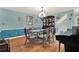 Dining room features hardwood floors, china cabinet, seating for six and a piano at 101 Carlyle Dr, Palm Harbor, FL 34683