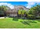 This charming home features multiple decks, lush landscaping, and a well-manicured lawn, creating a welcoming outdoor space at 101 Carlyle Dr, Palm Harbor, FL 34683