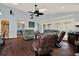 Spacious living room with ample seating, ceiling fan, and access to the dining and kitchen areas at 101 Carlyle Dr, Palm Harbor, FL 34683
