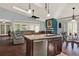 Open concept living room with kitchen island, fireplace, comfortable seating and dining area with great flow at 101 Carlyle Dr, Palm Harbor, FL 34683