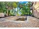 The inground pool, framed by a brick patio and lush palm trees, awaits renovation, promising a tranquil outdoor retreat at 101 Carlyle Dr, Palm Harbor, FL 34683