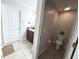 A bathroom features a single vanity with granite countertops and tile flooring and a separate room for the toilet at 10221 Carloway Hills Dr, Wimauma, FL 33598