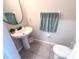 Bathroom featuring a granite sink countertop, a round mirror and a white toilet and tile flooring at 10221 Carloway Hills Dr, Wimauma, FL 33598