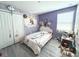 Cozy bedroom featuring playful decor, a window with blinds, and ample storage in the closet at 10221 Carloway Hills Dr, Wimauma, FL 33598